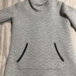 Grey cozy neck hoodie. Black stitching. Thumb slots